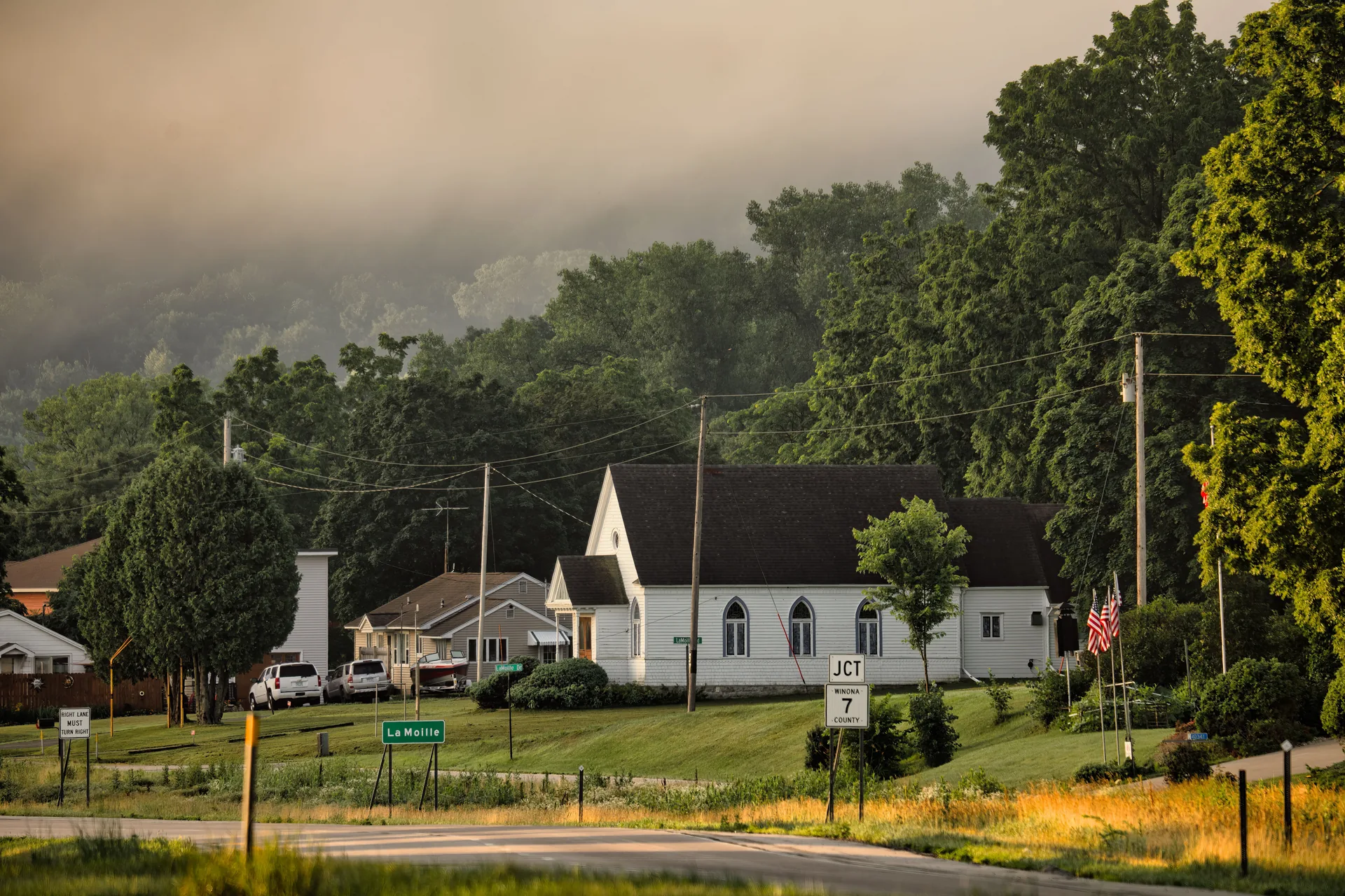 Foggy morning in a small town with a white church