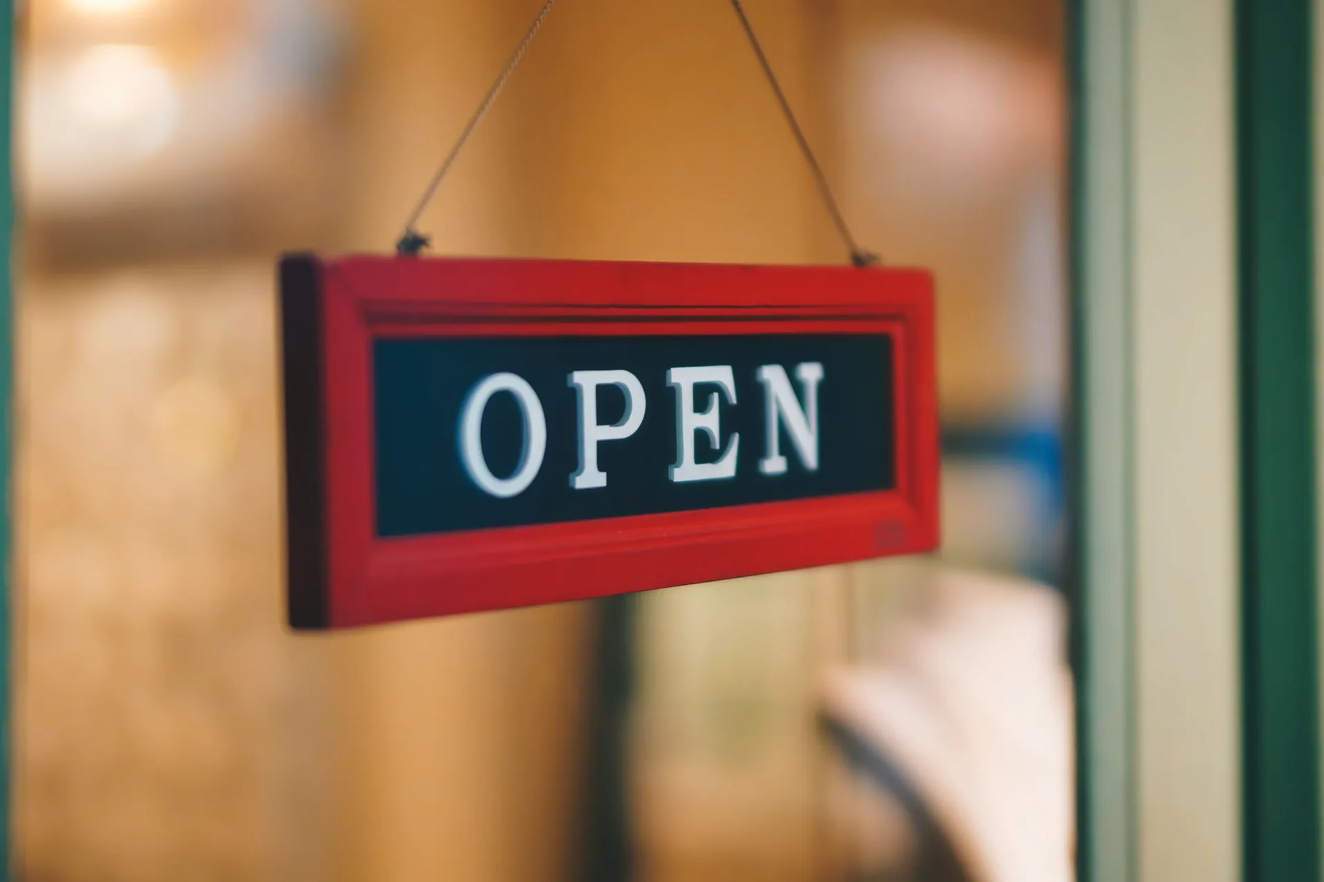 OPEN sign hanging in a shop window