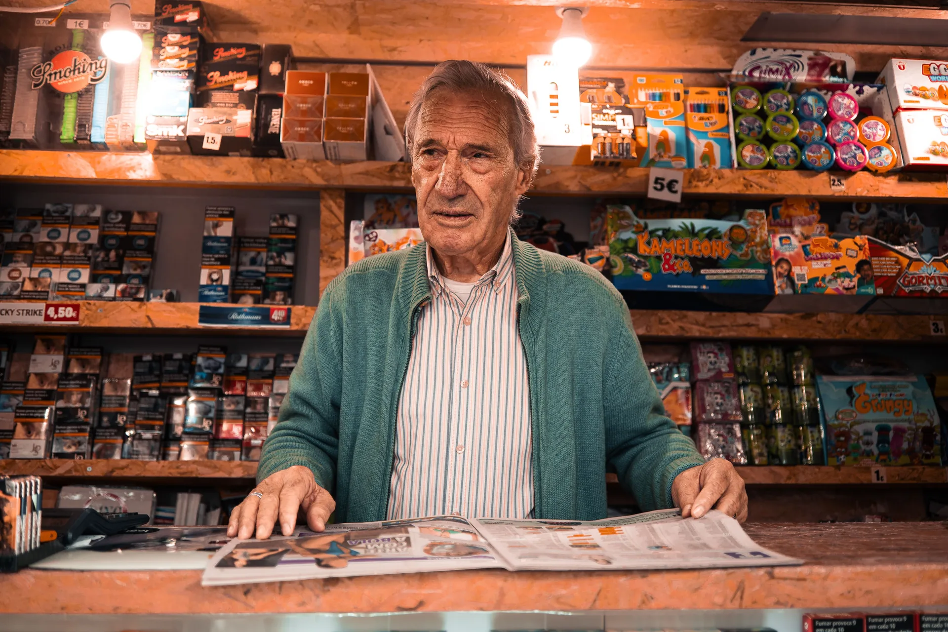 Shopkeeper behind the counter of a neighborhood store