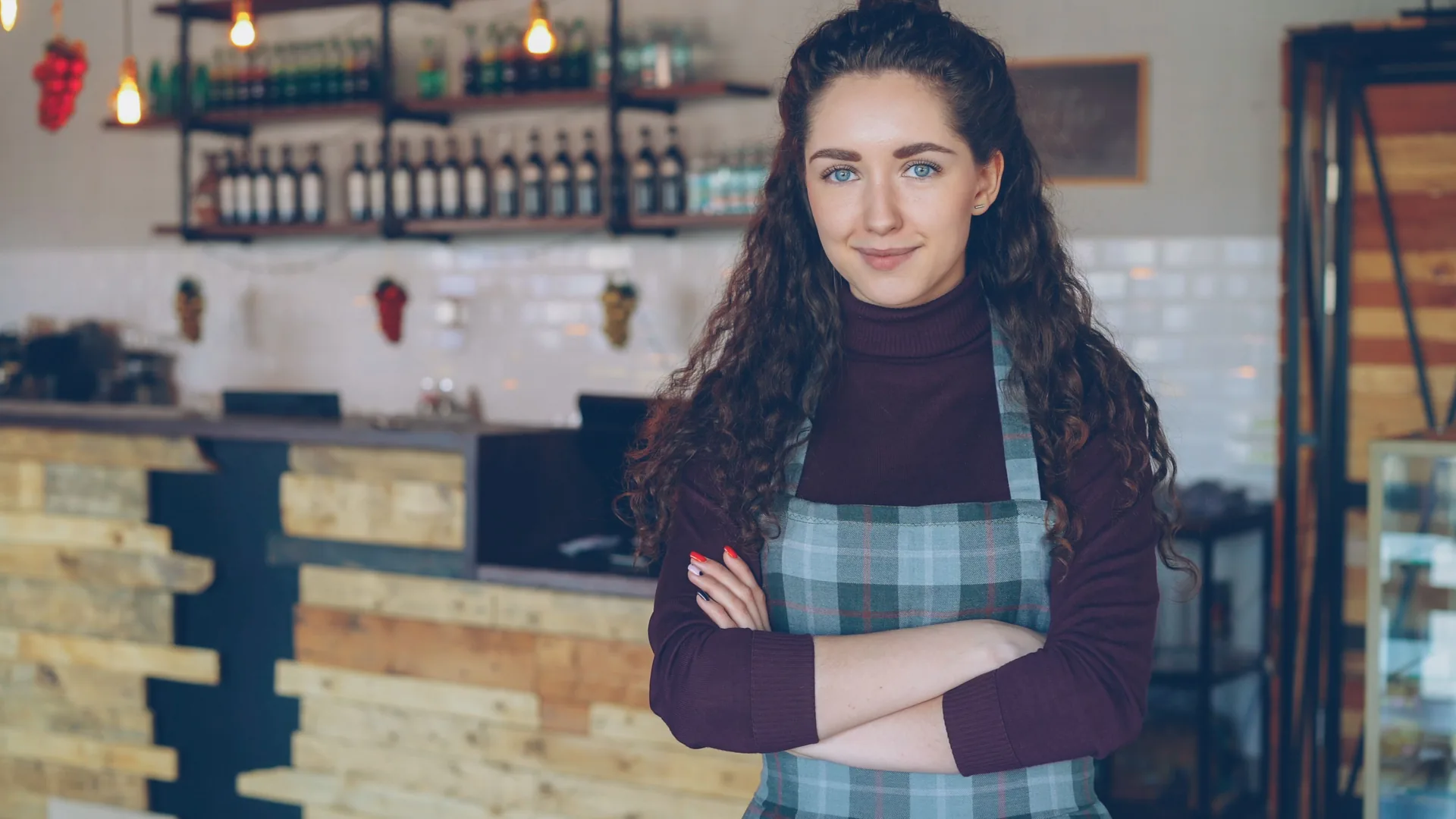 Cafe owner standing in her coffee shop