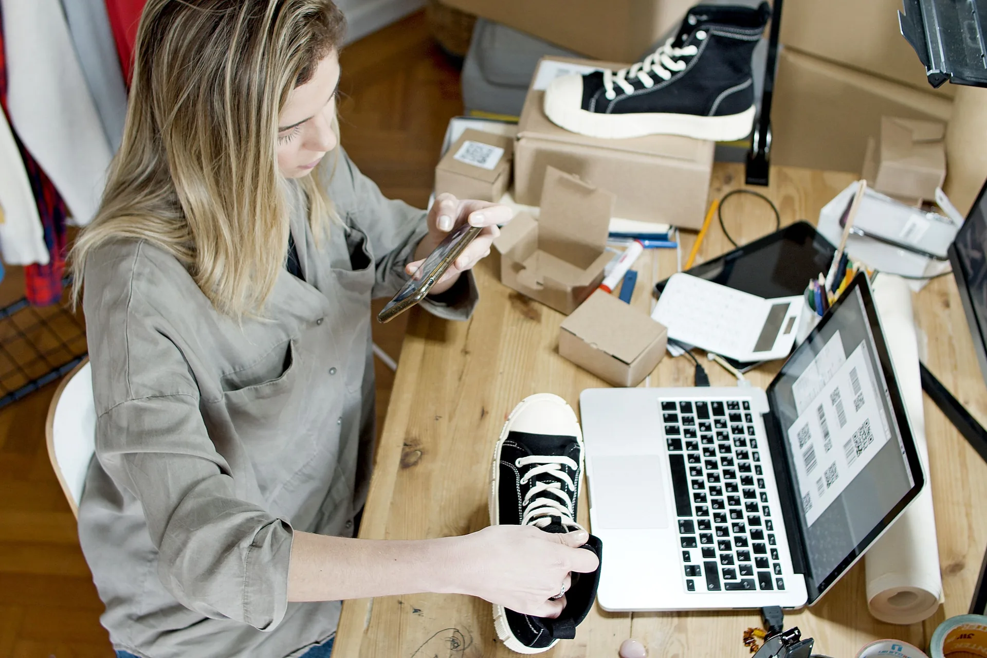 Shop owner photographing products for online orders